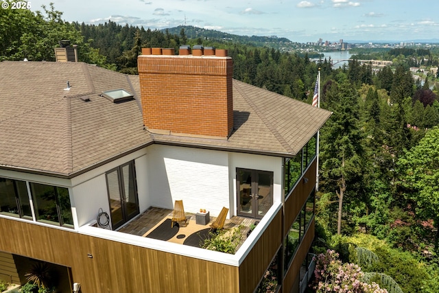 back of property featuring a balcony