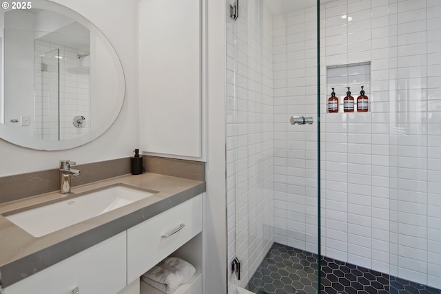 bathroom with vanity and a tile shower