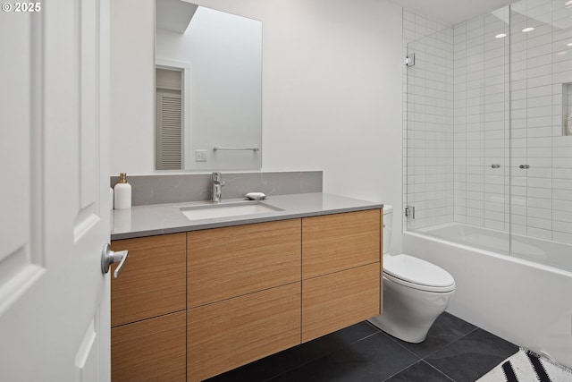 full bathroom with tile patterned flooring, bath / shower combo with glass door, vanity, and toilet