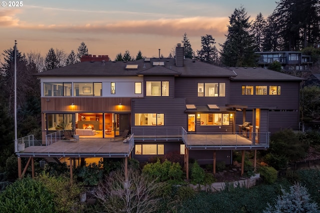 back house at dusk featuring an outdoor living space