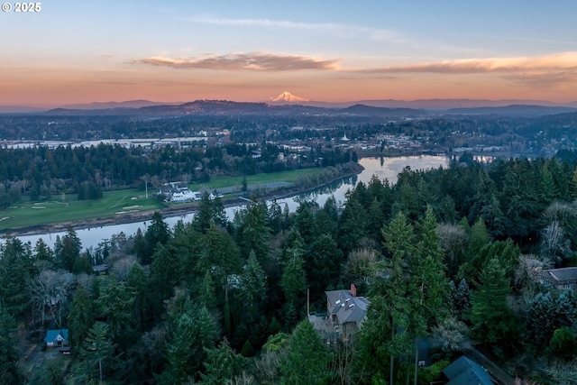 aerial view at dusk with a water and mountain view