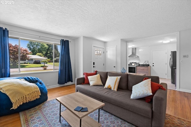 1637 Camino Dr, Forest Grove, OR 97116 - living room with wood finished floors, baseboards, plenty of natural light, and a textured ceiling