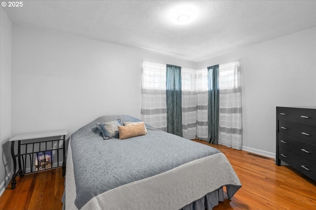 1637 Camino Dr, Forest Grove, OR 97116 - bedroom featuring wood finished floors, baseboards, and a textured ceiling