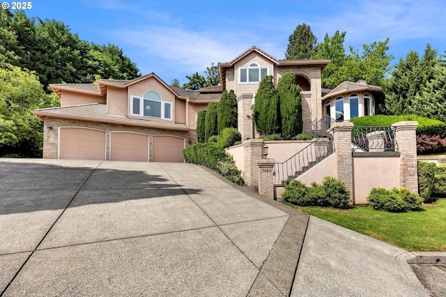 3420 SE 144th Ct, Vancouver, WA 98683 - view of front of home with stairs, driveway, a garage, and brick siding