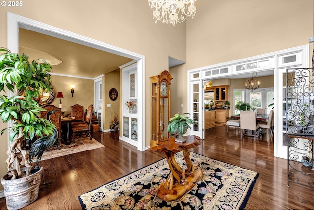 3420 SE 144th Ct, Vancouver, WA 98683 - living area with a chandelier, wood finished floors, a high ceiling, and baseboards