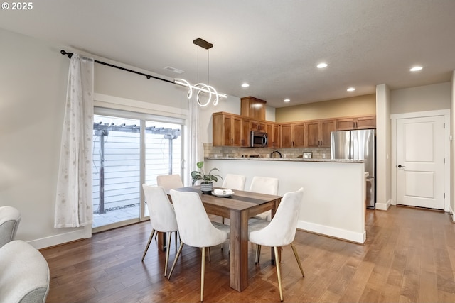 dining area with recessed lighting, wood finished floors, visible vents, and baseboards