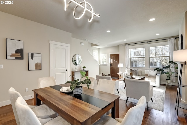 dining room featuring baseboards, wood finished floors, and recessed lighting