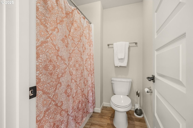 9703 NE 106th St, Vancouver, WA 98662 - full bath with wood finished floors, baseboards, toilet, and a shower with shower curtain