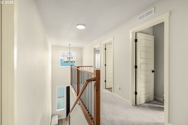 9703 NE 106th St, Vancouver, WA 98662 - hall with an upstairs landing, a chandelier, carpet floors, and baseboards