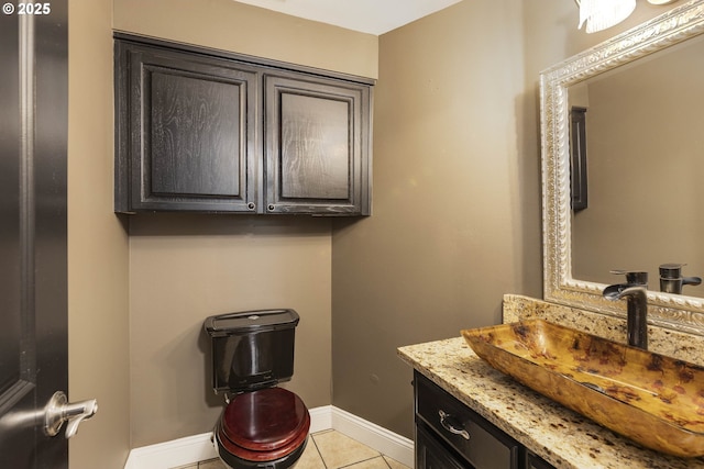 bathroom with baseboards, tile patterned flooring, and vanity