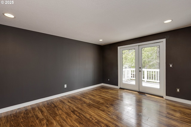 empty room featuring french doors, recessed lighting, baseboards, dark wood-type flooring, and visible vents