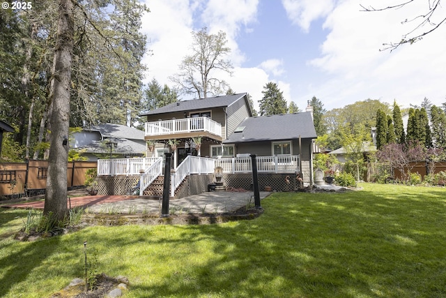 rear view of property with a patio area, a wooden deck, a chimney, and fence