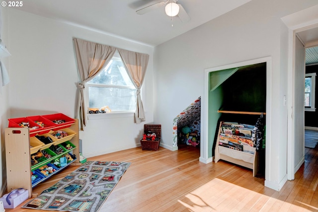 recreation room with hardwood / wood-style floors and ceiling fan