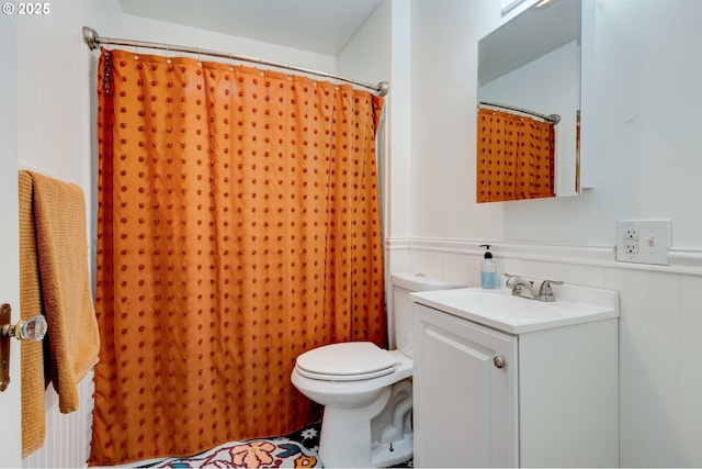 bathroom featuring vanity, curtained shower, and toilet