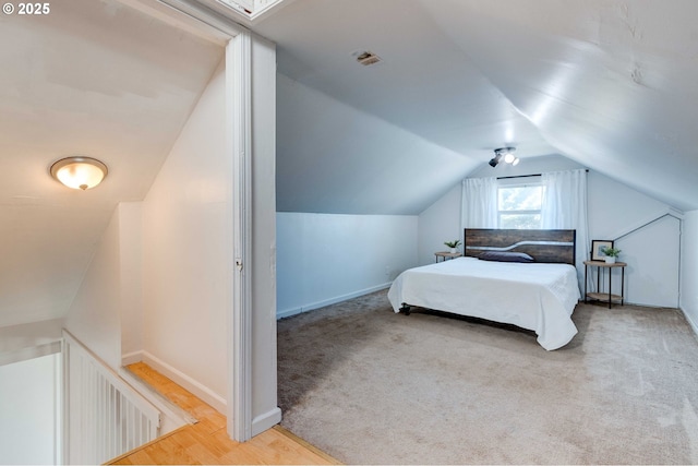 carpeted bedroom with vaulted ceiling