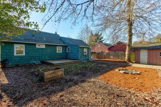 back of property featuring a storage shed and a patio