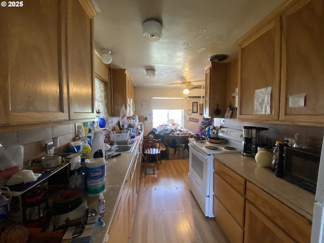 35001 Seavey Loop Rd, Eugene, OR 97405 - kitchen with white range with electric stovetop, light wood finished floors, tasteful backsplash, and black microwave