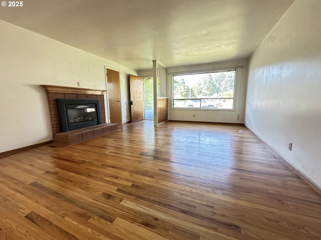 3032 NW Grant Ave, Corvallis, OR 97330 - unfurnished living room featuring wood finished floors and a fireplace