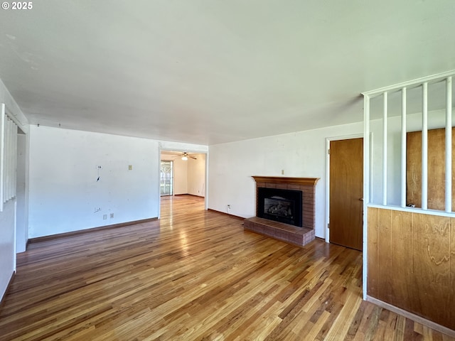 3032 NW Grant Ave, Corvallis, OR 97330 - unfurnished living room with wood finished floors, a brick fireplace, and ceiling fan