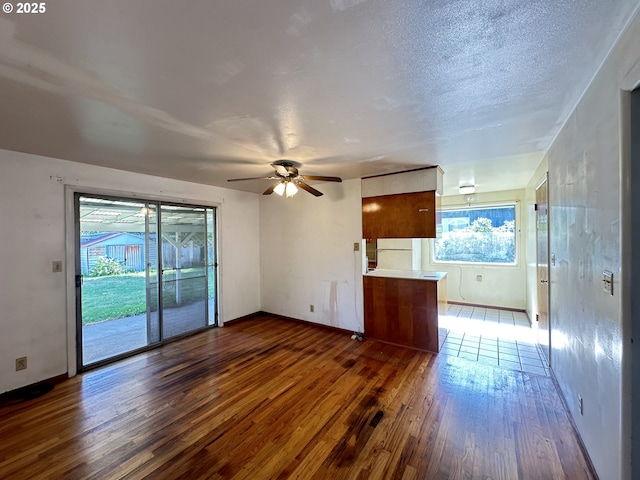3032 NW Grant Ave, Corvallis, OR 97330 - unfurnished living room featuring dark wood-type flooring and a ceiling fan