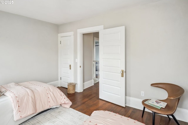 bedroom with baseboards and wood finished floors