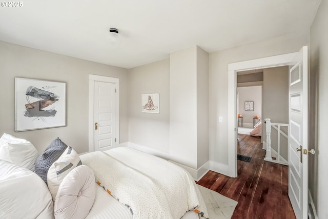 bedroom featuring baseboards and wood finished floors