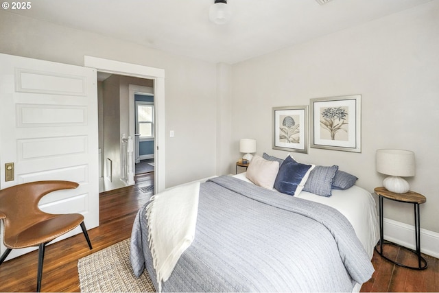 bedroom featuring baseboards and wood finished floors