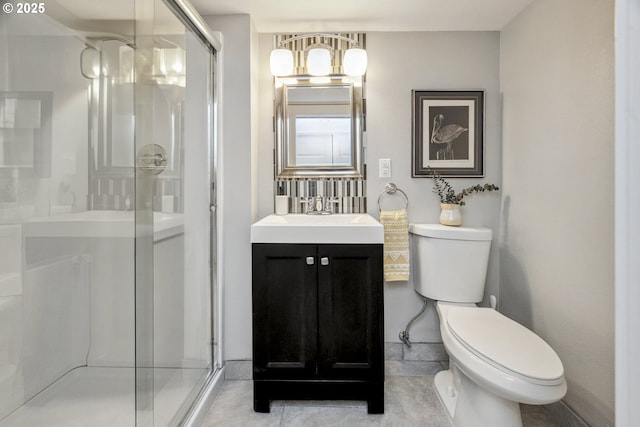 bathroom featuring vanity, a shower stall, and toilet