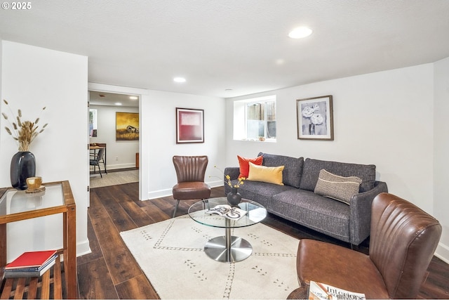 living area featuring recessed lighting, baseboards, and wood-type flooring