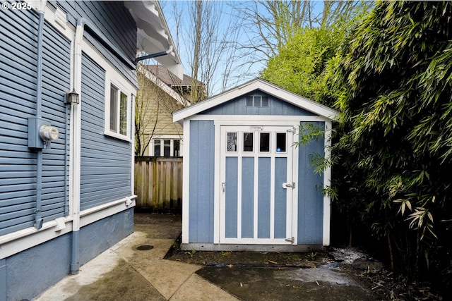 view of shed featuring fence