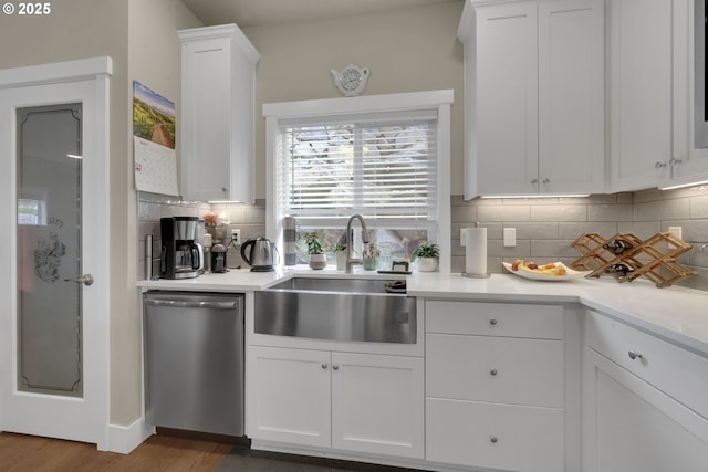 3783 Rockcress Rd, Eugene, OR 97403 - kitchen with stainless steel dishwasher, a sink, backsplash, white cabinets, and light countertops