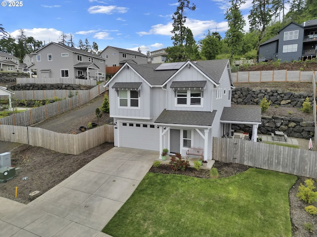 3783 Rockcress Rd, Eugene, OR 97403 - view of front of house featuring a shingled roof, a garage, concrete driveway, a residential view, and roof mounted solar panels