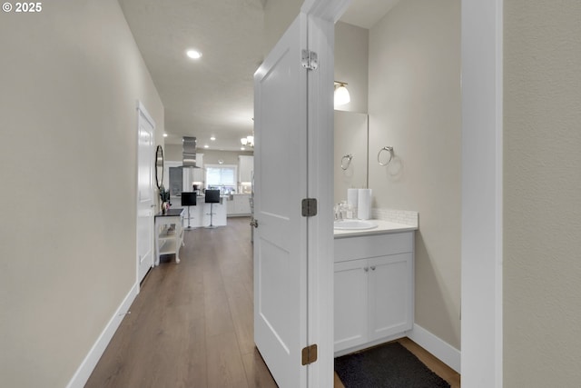 3783 Rockcress Rd, Eugene, OR 97403 - corridor with a sink, wood finished floors, recessed lighting, and baseboards
