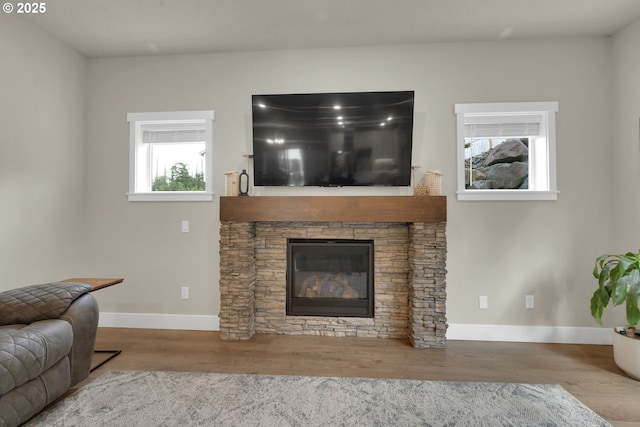 3783 Rockcress Rd, Eugene, OR 97403 - living area with a stone fireplace, wood finished floors, and baseboards