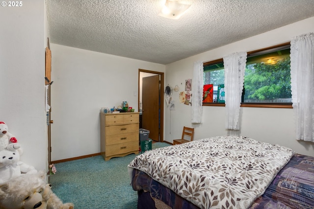 bedroom with carpet flooring and a textured ceiling