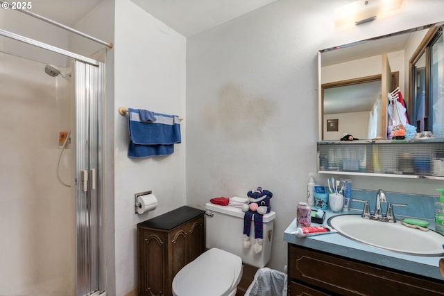 full bath with a shower stall, toilet, and vanity