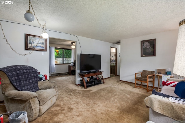 carpeted living area featuring a textured ceiling and a ceiling fan