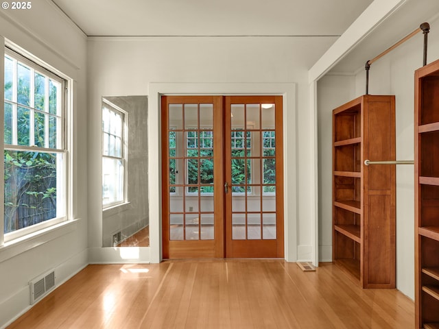 doorway to outside featuring french doors and wood finished floors