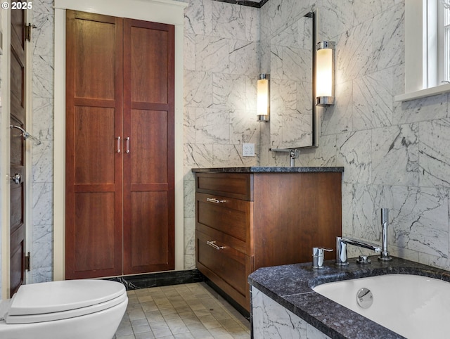 full bath featuring vanity and toilet