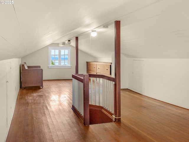 additional living space featuring hardwood / wood-style flooring and vaulted ceiling