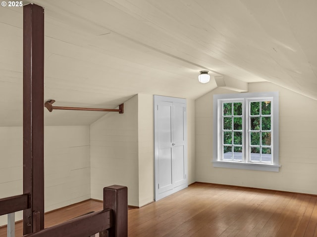 bonus room with vaulted ceiling and hardwood / wood-style flooring
