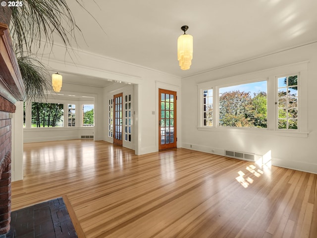 unfurnished living room featuring wood finished floors and baseboards