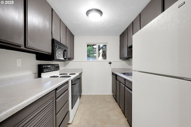 kitchen featuring white appliances, light countertops, and baseboards