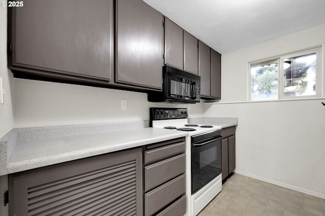 kitchen with black microwave, range with electric stovetop, baseboards, light countertops, and gray cabinets