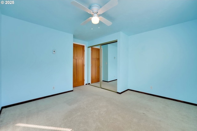 unfurnished bedroom with carpet floors, ceiling fan, baseboards, and a closet