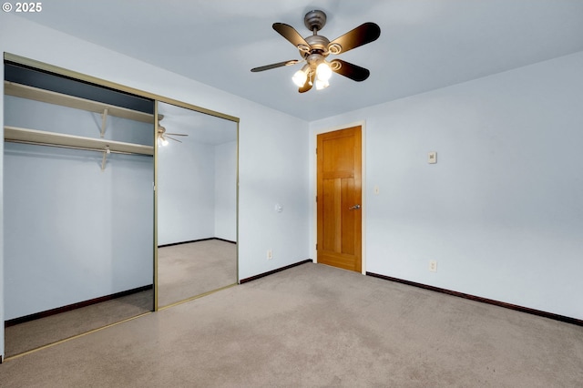 unfurnished bedroom featuring a closet, carpet flooring, a ceiling fan, and baseboards