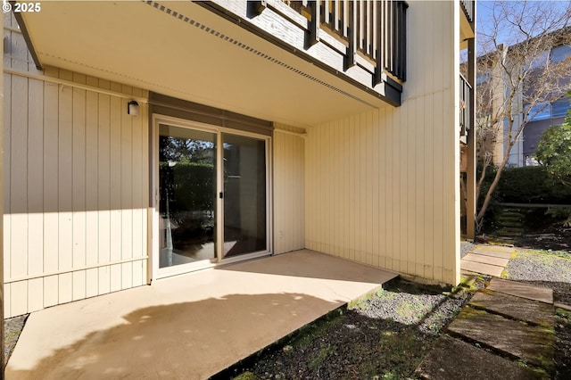 entrance to property featuring a patio area and a balcony