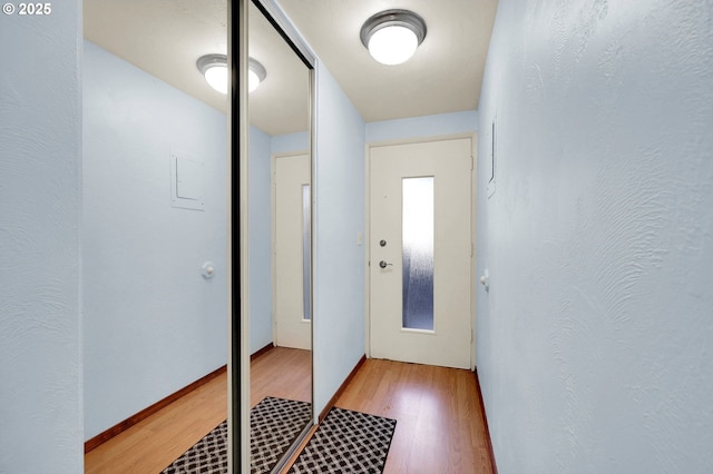 entryway featuring a textured wall and light wood-style flooring