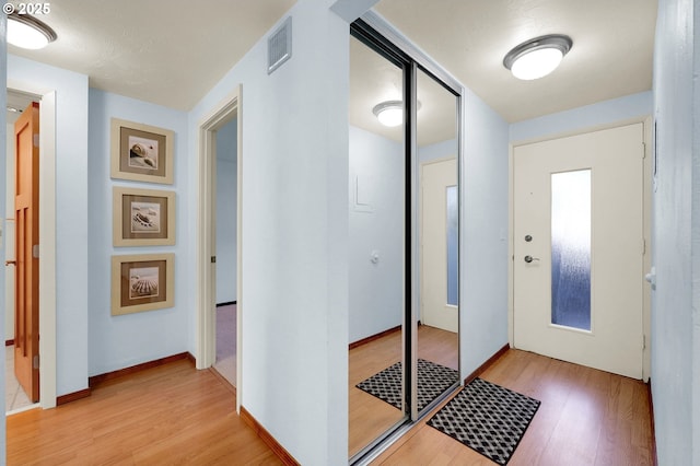 entryway featuring light wood-type flooring and visible vents