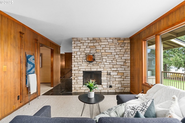 living area featuring a stone fireplace and wooden walls